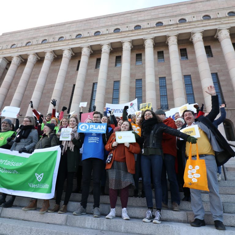 Fingon jäsenjärjestöjen edustajia iloisena eduskuntatalon portailla