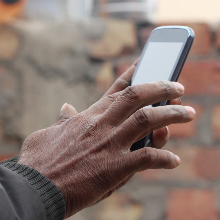 Man holding a mobile device.