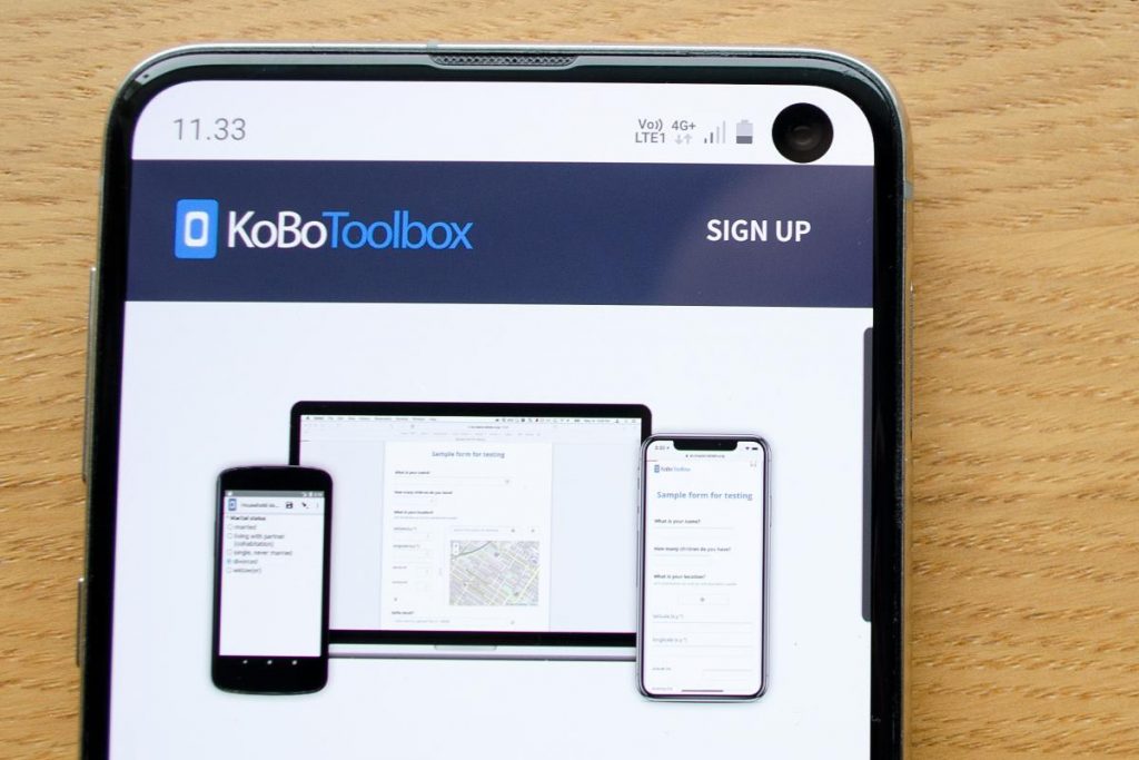 Mobile phone with KoBoToolbox website.