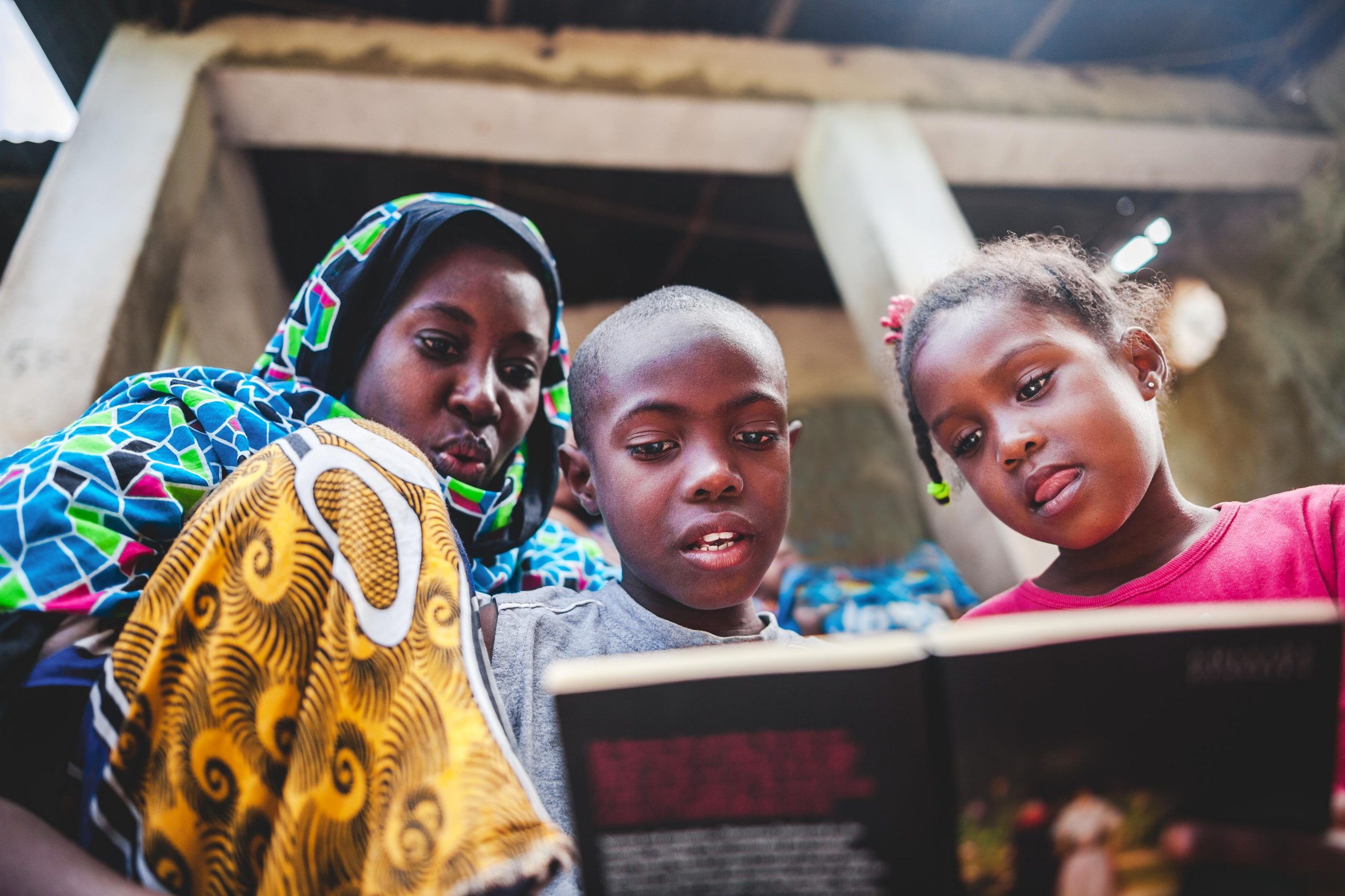 African children doing their homework with their mother