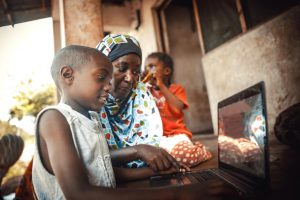 Photo of an African family on a laptop.